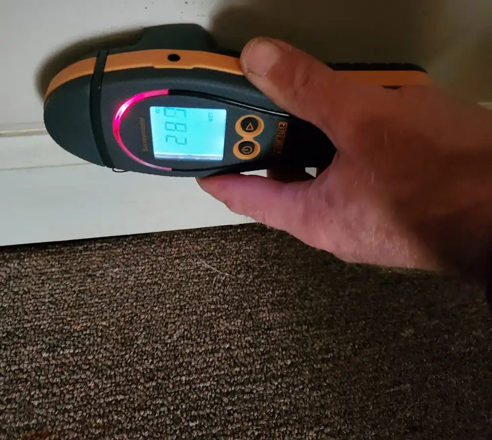 Moisture detection at baseboard during Storm Damage Restoration in Snyder